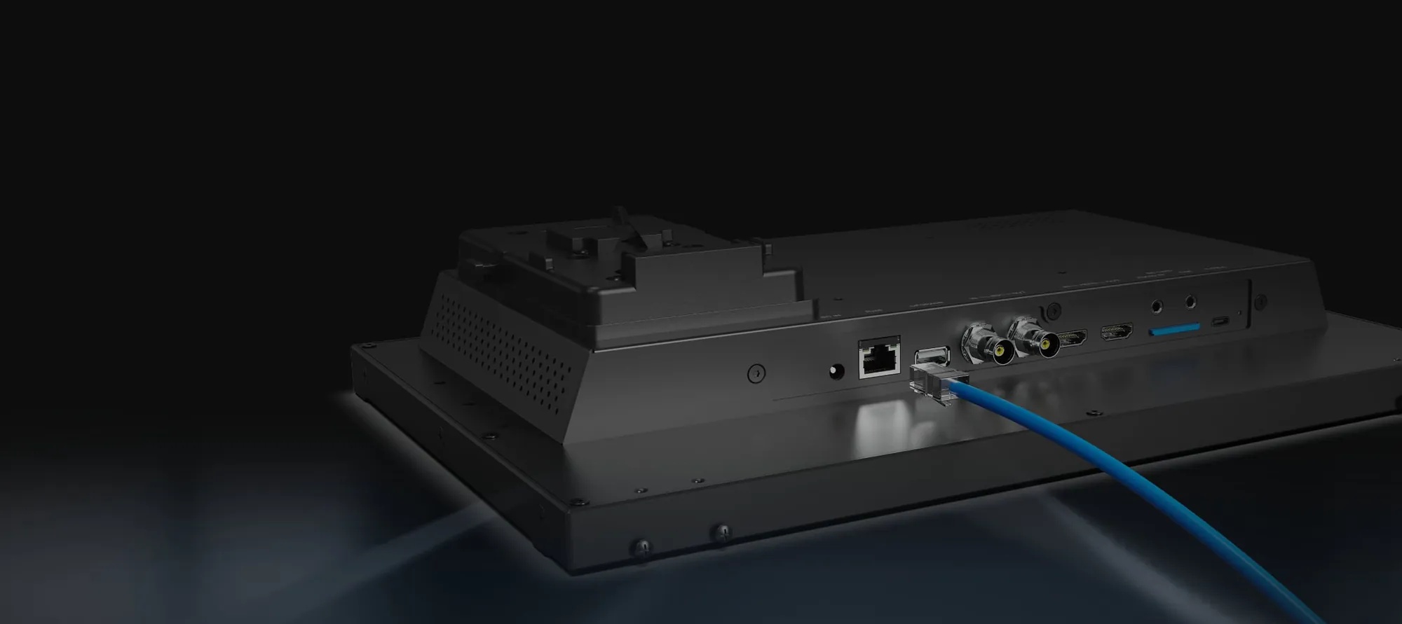 PVM160S-E rear panel with a LAN cable connected, V-lock battery mount and HDMI, 3G-SDI and SD card ports